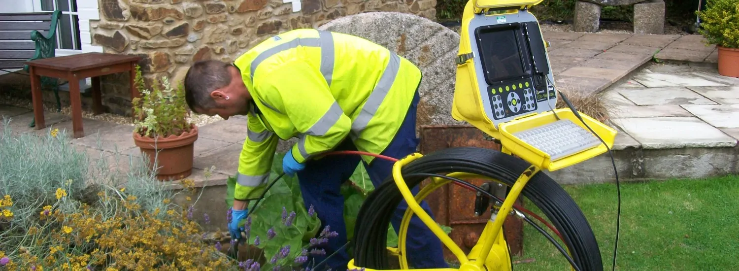 Drain pipe repair work being done near a residential property in Weymouth